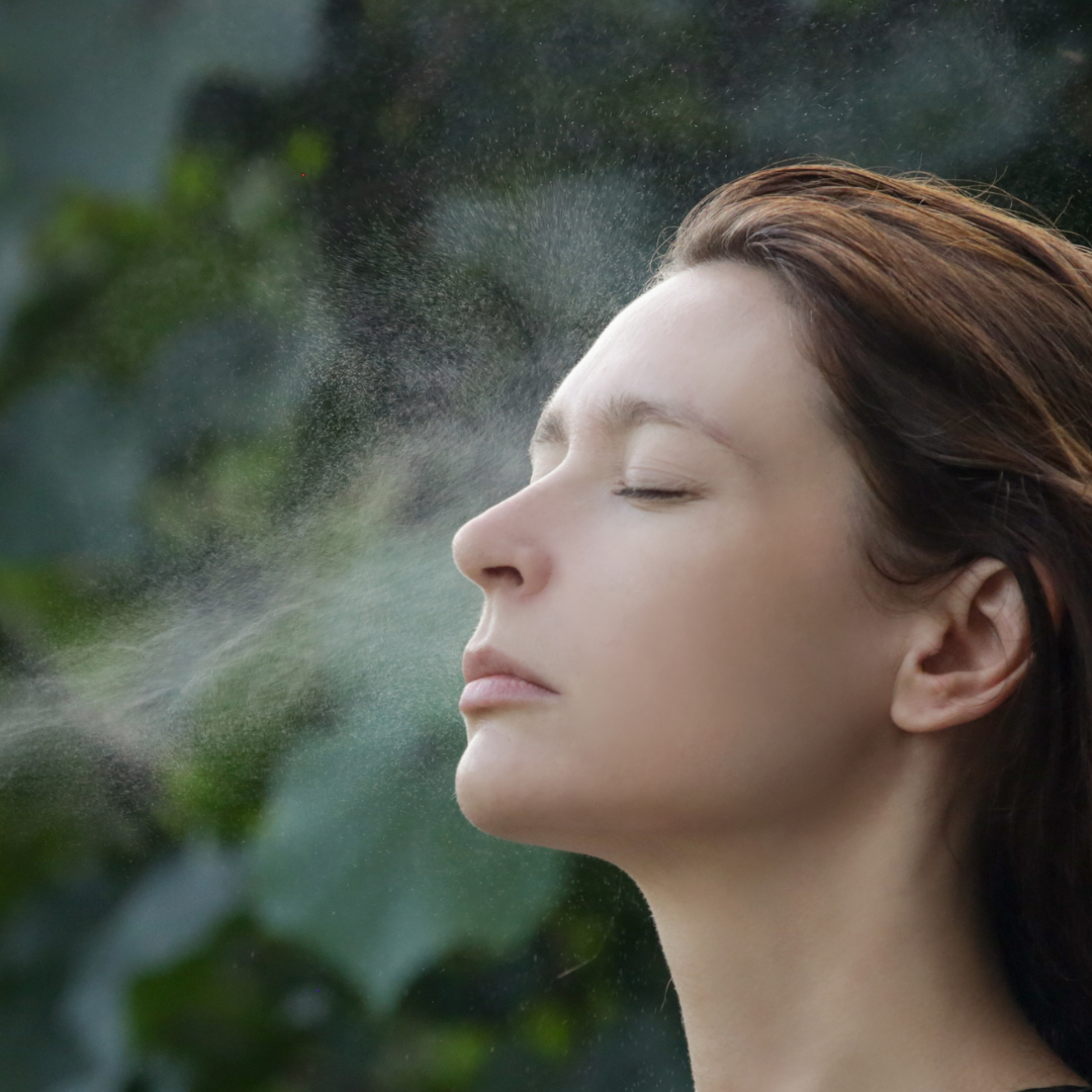 Spraying B-complex toner onto face