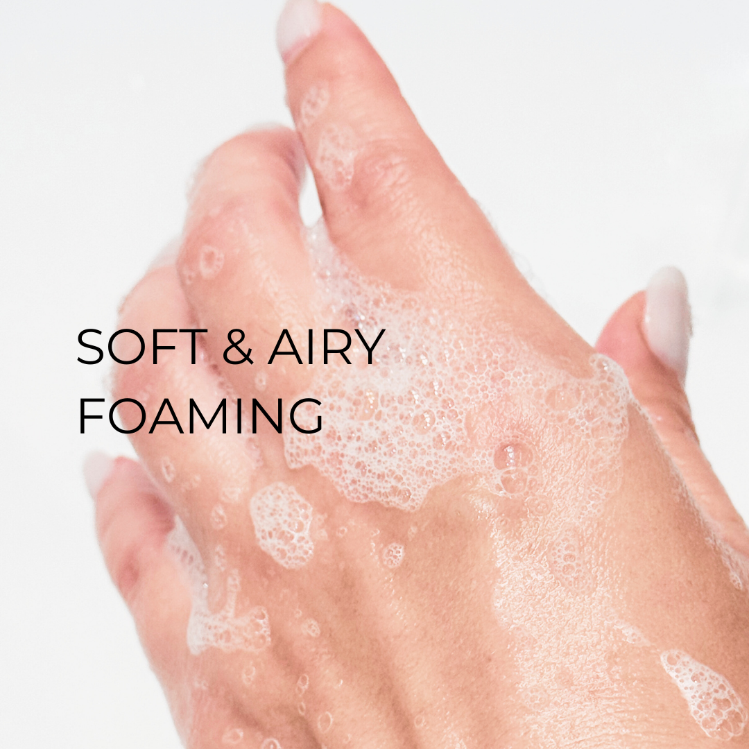 Soft & airy foaming: Hand holding soft, airy foam from Lumi Foam Gel Cleanser, showing its light and refreshing texture.